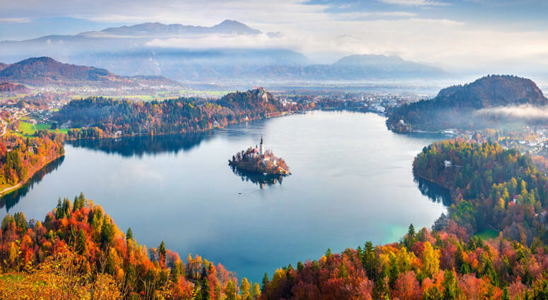 Aerial view of church of Assumption of Maria on the Bled lake. Sunny autumn landscape in Julian Alps