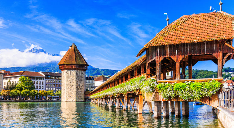 Lucerne, Switzerland. Historic city center with its famous Chapel Bridge and Mt. Pilatus on the background