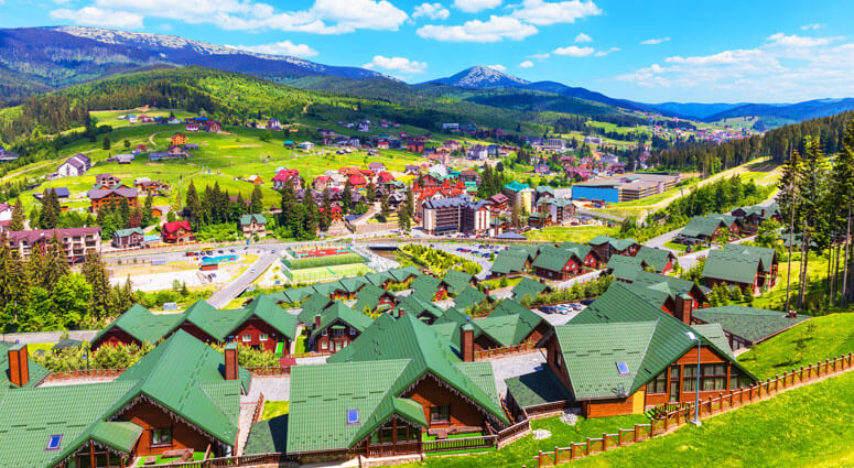Scenic summer view of winter ski resort with house and cottage in Bukovel, Carpathian Mountains, Ukraine